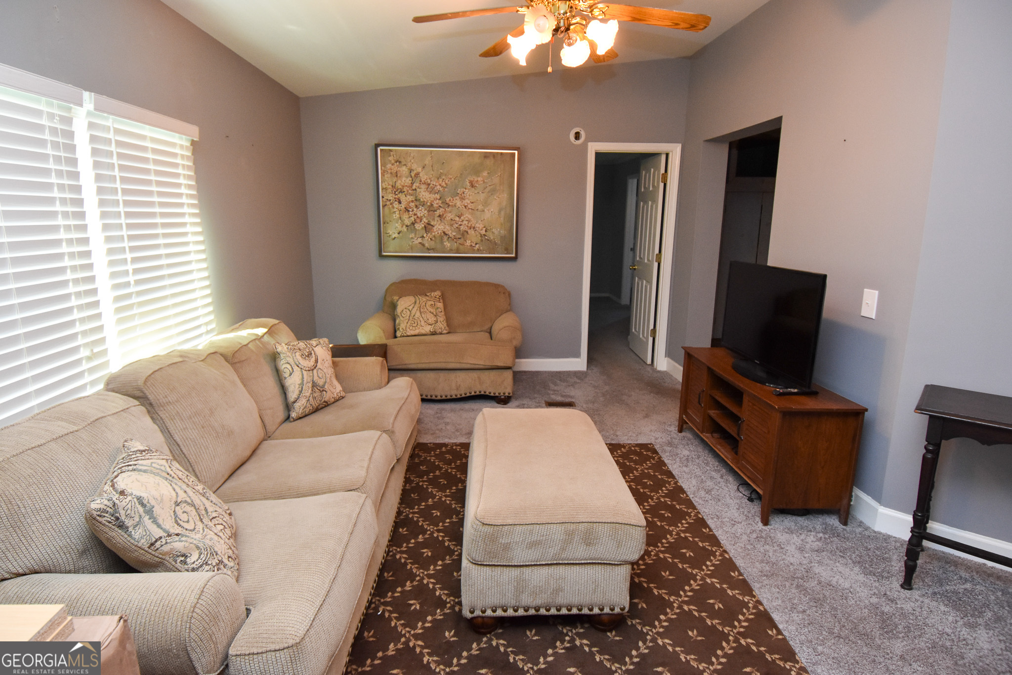 1256 Vaughn Road Griffin, GA 30223 - Photo 9 of 73 a living room with furniture a flat screen tv and a window