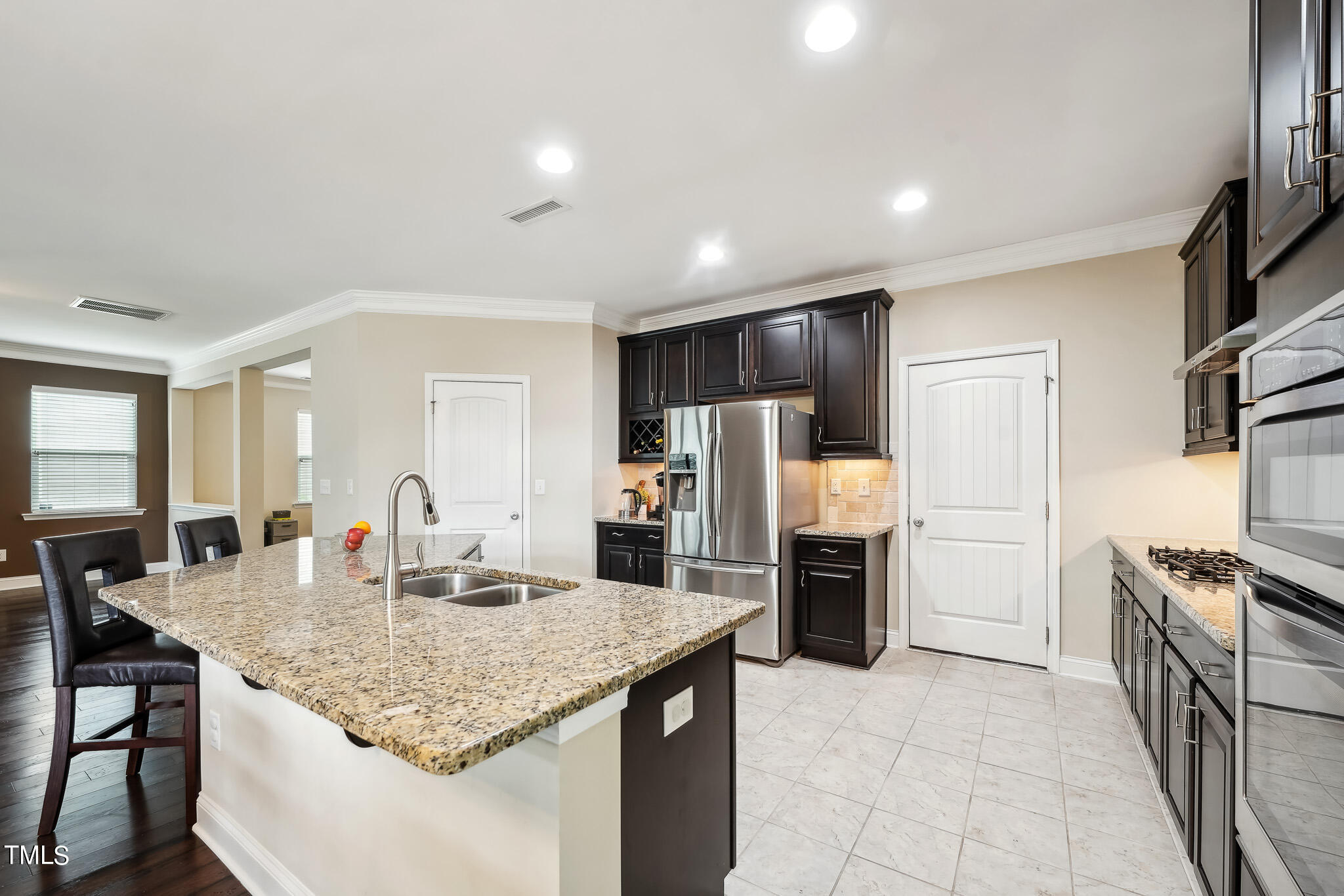 5608 Spring Glen Lane Raleigh, NC 27616 - Photo 11 of 30 a kitchen with stainless steel appliances granite countertop a sink refrigerator and cabinets