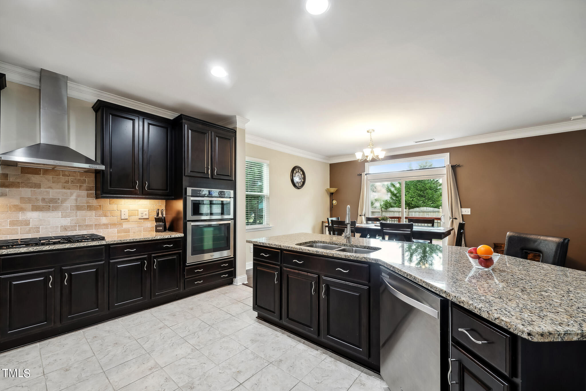5608 Spring Glen Lane Raleigh, NC 27616 - Photo 13 of 30 a kitchen with a sink and wooden cabinets