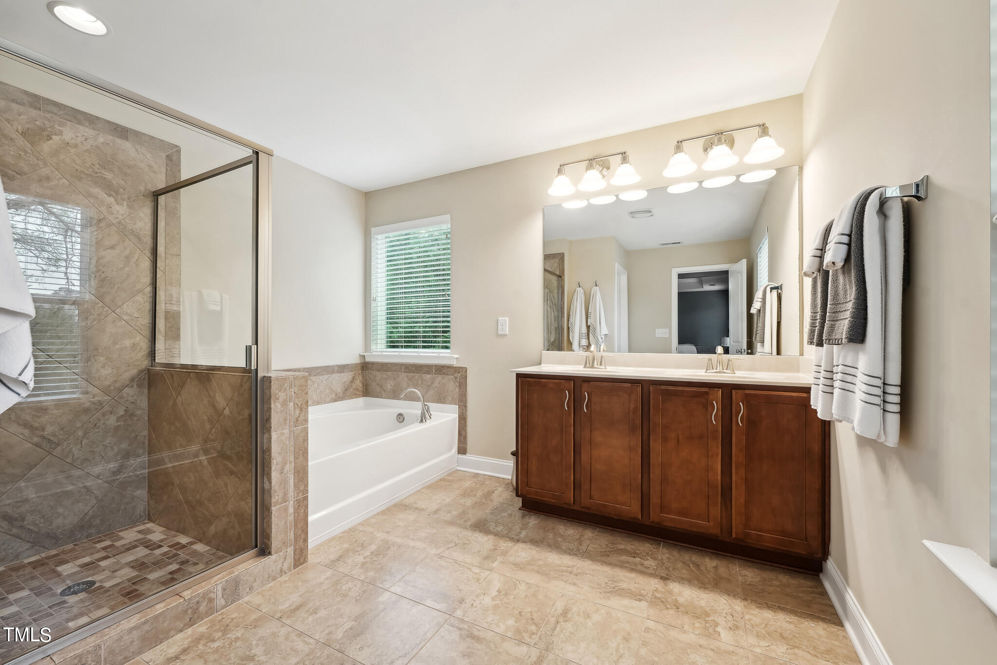 5608 Spring Glen Lane Raleigh, NC 27616 - Photo 21 of 30 a spacious bathroom with a tub sink and mirror
