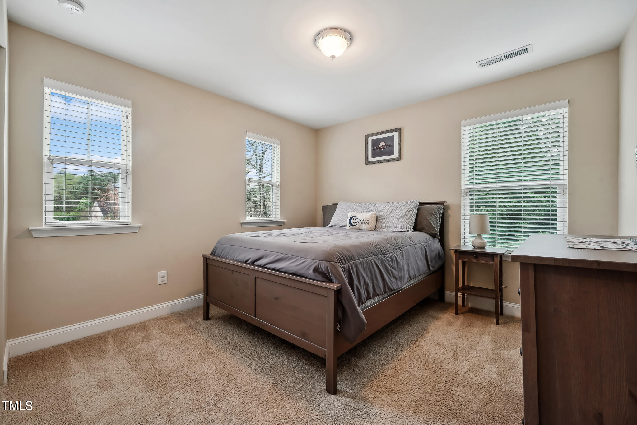 5608 Spring Glen Lane Raleigh, NC 27616 - Photo 25 of 30 a bed sitting in a bedroom next to a window