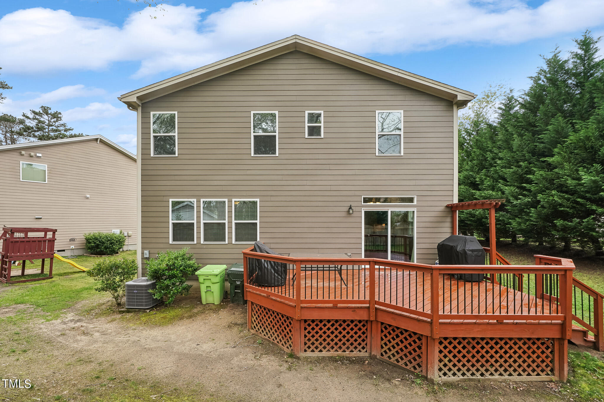 5608 Spring Glen Lane Raleigh, NC 27616 - Photo 27 of 30 a view of a house with a small deck and a yard