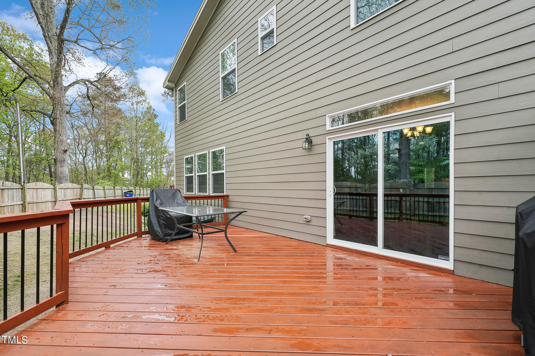 5608 Spring Glen Lane Raleigh, NC 27616 - Photo 29 of 30 a view of a patio with a table and chairs next to a large window