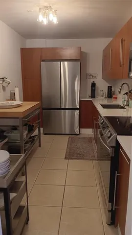 a kitchen with a sink appliances and cabinets