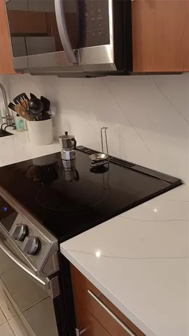 a large bed in a bedroom next to a window