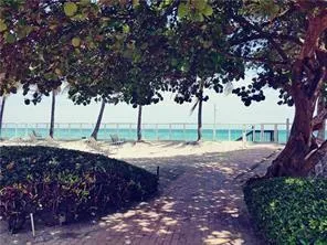 a front view of a building with trees