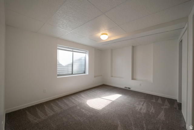 11922 Bluff View Drive Sandy, UT 84092 - Photo 16 of 30 Carpeted empty room with a paneled ceiling and baseboards