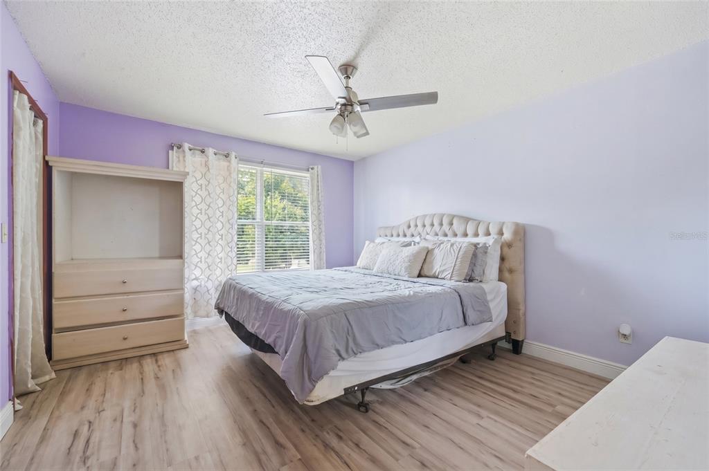 3027 Queens Gate Road Orlando, FL 32818 - Photo 27 of 34 a bedroom with a bed and window