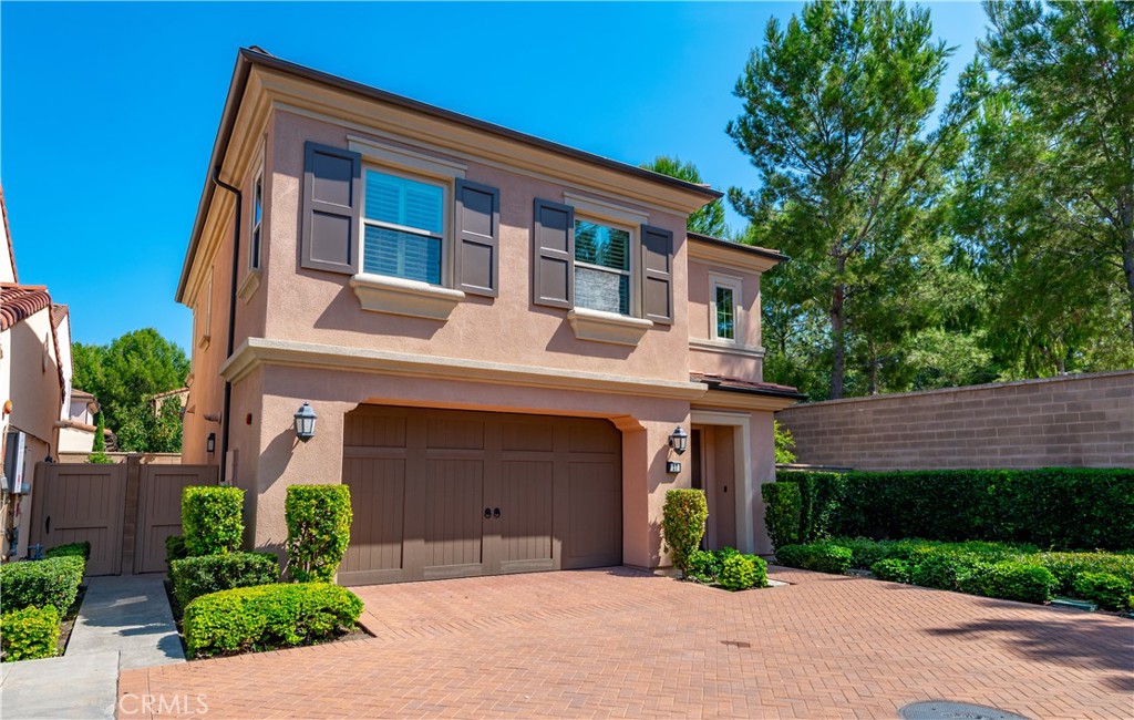 27 Oakfield Irvine, CA 92620 - Photo 1 of 1 a front view of a house with a yard and garage