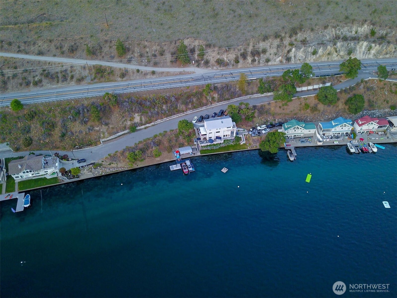 2650 South Lakeshore Road Chelan, WA 98816 - Photo 1 of 10 an aerial view of a house with a yard lake lake and mountain view in back
