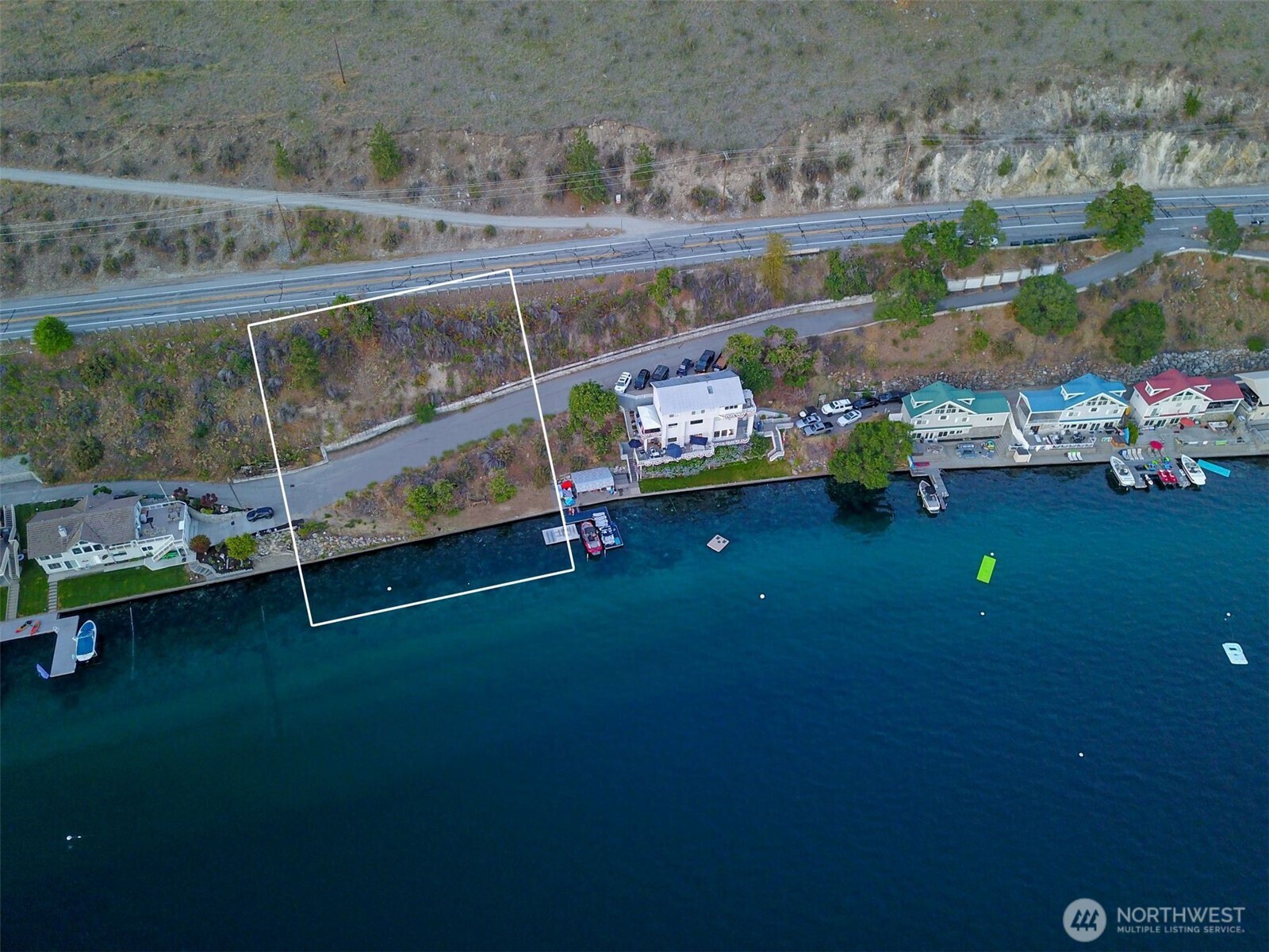 2650 South Lakeshore Road Chelan, WA 98816 - Photo 2 of 10 a backyard of a house with table and chairs