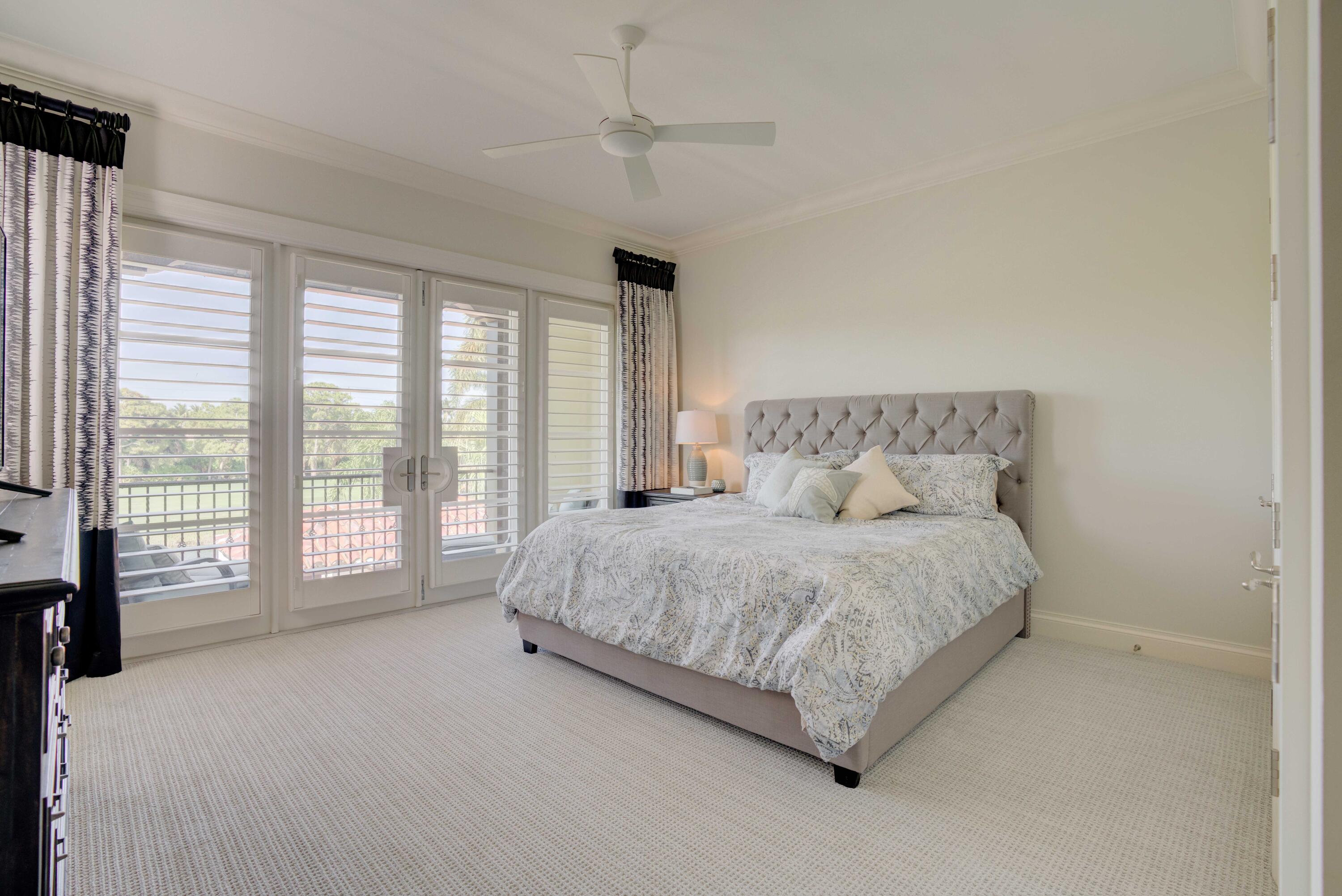 444 Red Hawk Drive Jupiter, FL 33477 - Photo 32 of 58 a spacious bedroom with a large bed and a large window