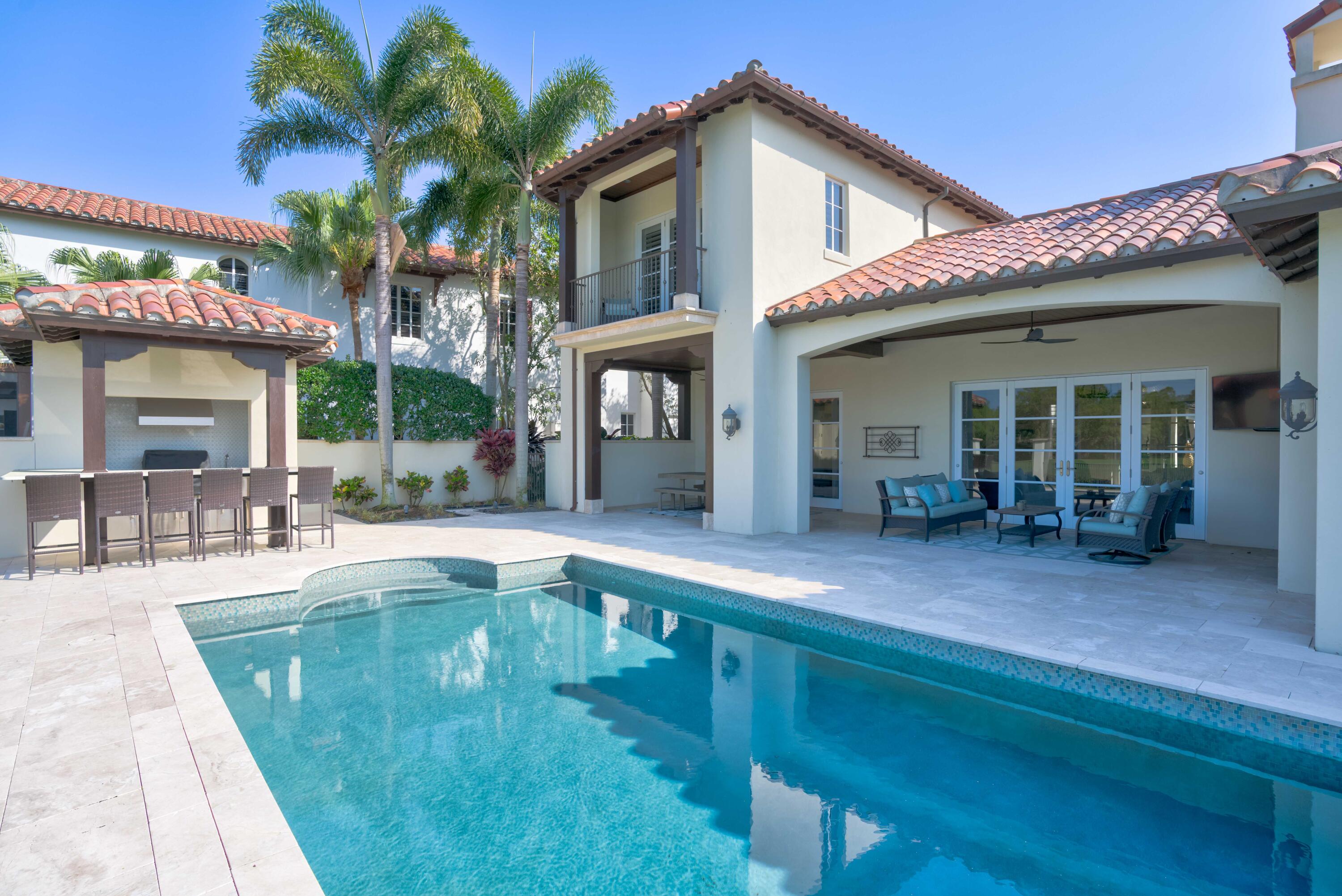 444 Red Hawk Drive Jupiter, FL 33477 - Photo 39 of 58 a view of a house with a swimming pool and sitting area