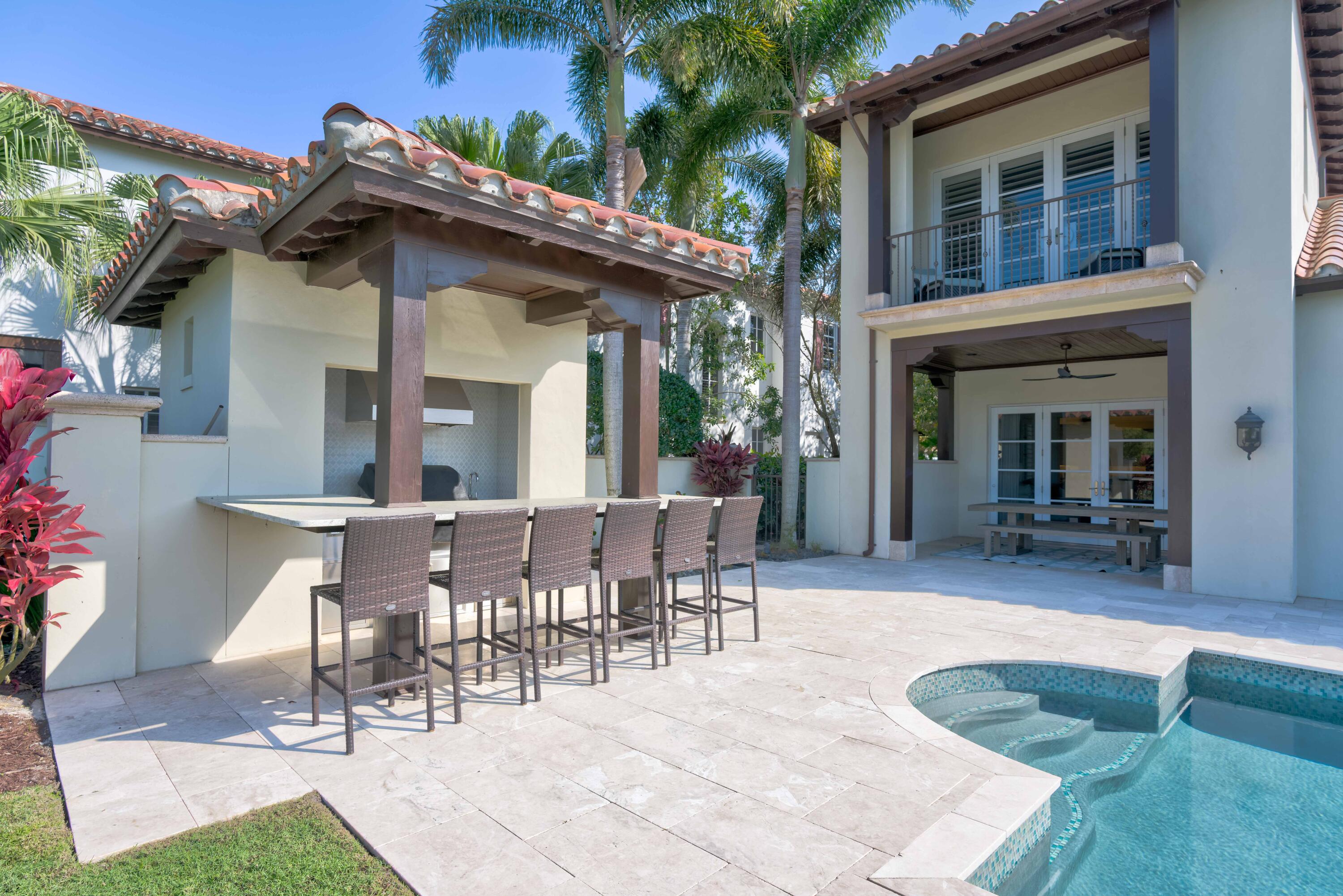 444 Red Hawk Drive Jupiter, FL 33477 - Photo 46 of 58 a view of a patio with table and chairs and potted plants