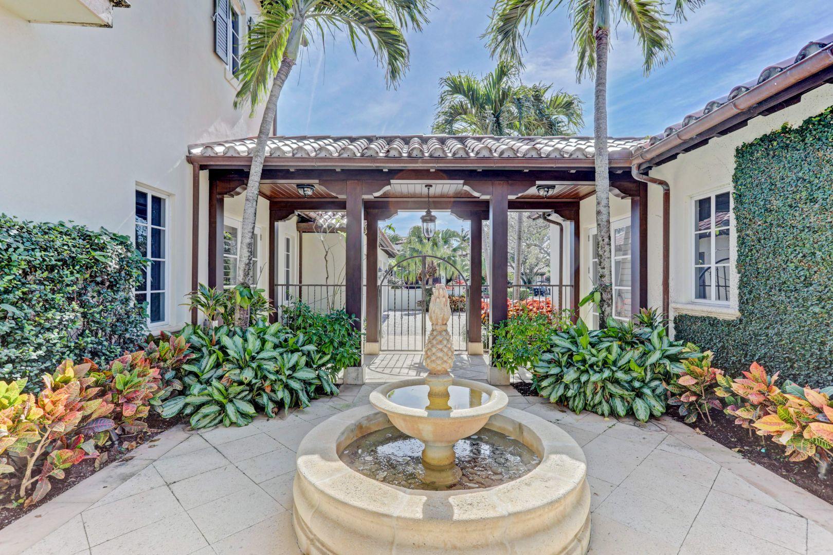 444 Red Hawk Drive Jupiter, FL 33477 - Photo 6 of 58 a front view of a house with a fountain