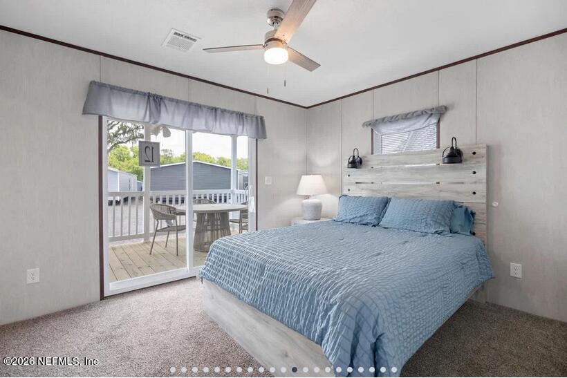 140 Islander Road Satsuma, FL 32189 - Photo 6 of 11 a bedroom with a large bed and a large window