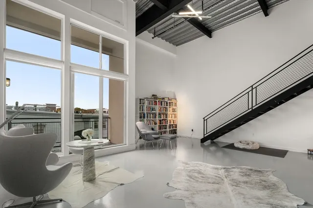 a living room with patio furniture and a large window