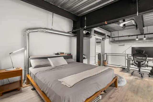 a bedroom with a bed and a table