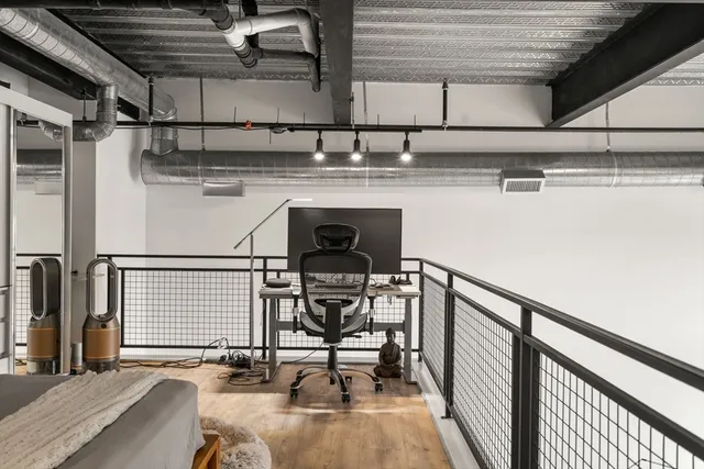 a view of a hallway with seating area
