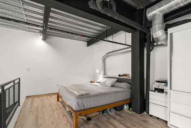 a view of a room with wooden floor