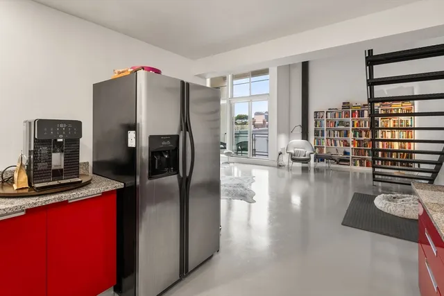 a kitchen with stainless steel appliances granite countertop a refrigerator a stove and a sink with dishwasher