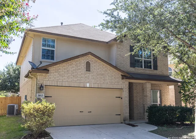 a view of a house with a yard and potted plants