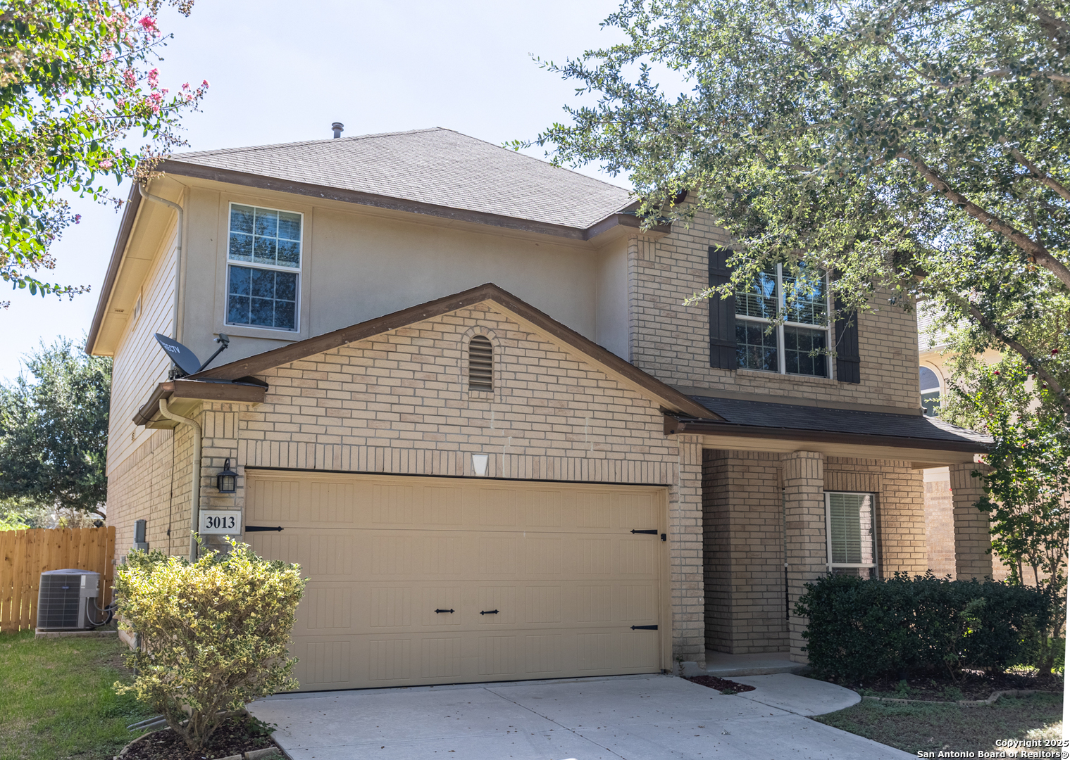 a view of a house with a yard and potted plants