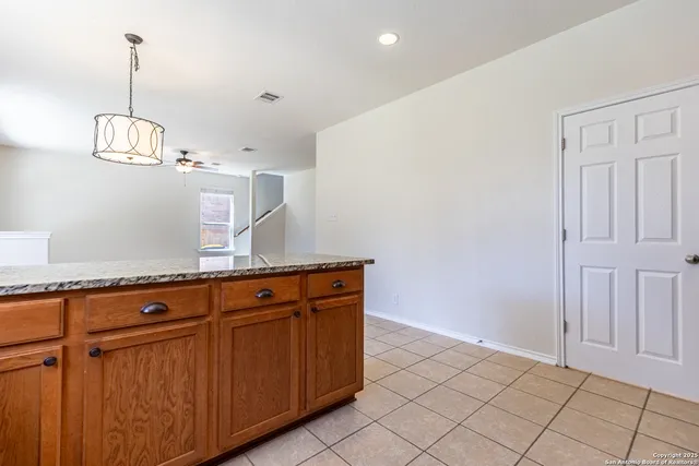 a view of a kitchen with granite countertop cabinets and wooden floor
