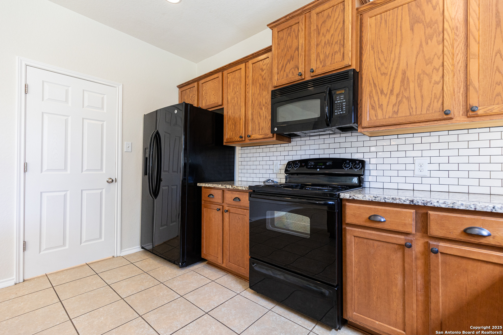 3013 Muntjac Schertz, TX 78154 - Photo 18 of 40 a kitchen with stainless steel appliances wooden cabinets and a stove top oven