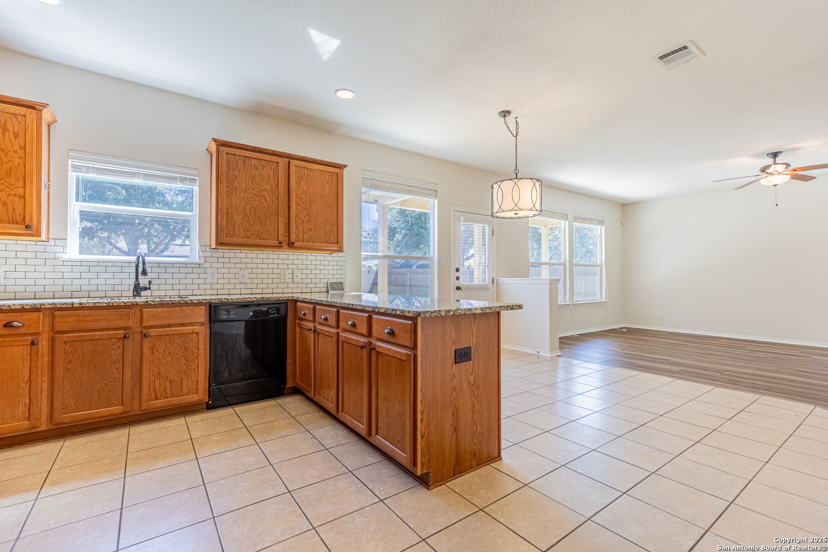 3013 Muntjac Schertz, TX 78154 - Photo 19 of 40 a kitchen with stainless steel appliances granite countertop a stove a sink and a microwave