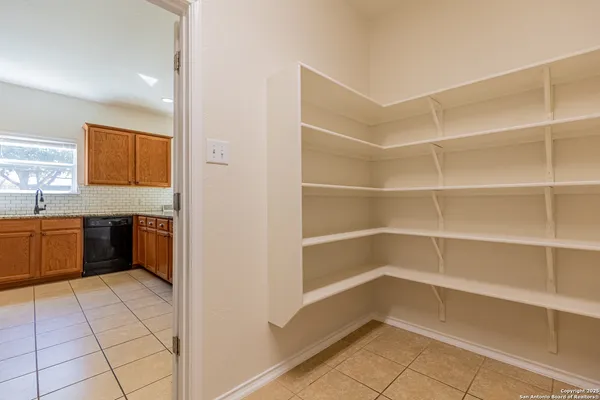 a view of a kitchen with a fridge and a sink