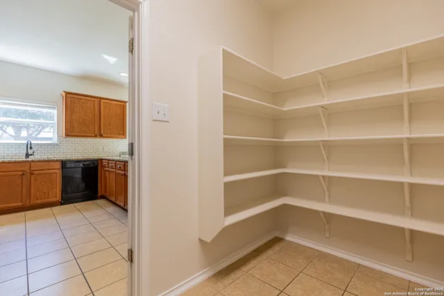 a view of a kitchen with a fridge and a sink