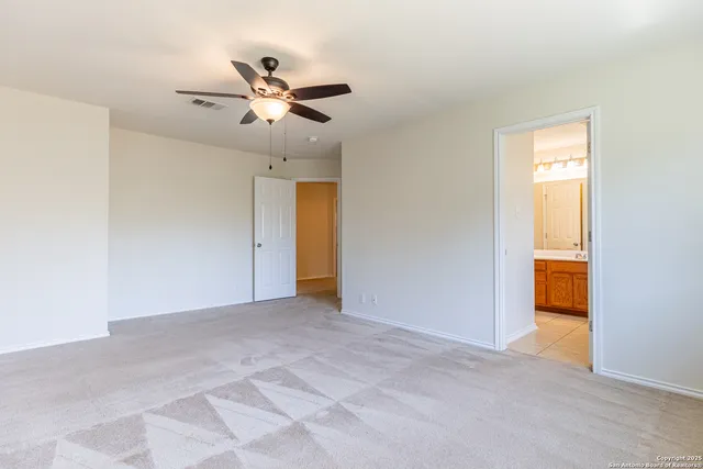 a view of empty room with ceiling fan
