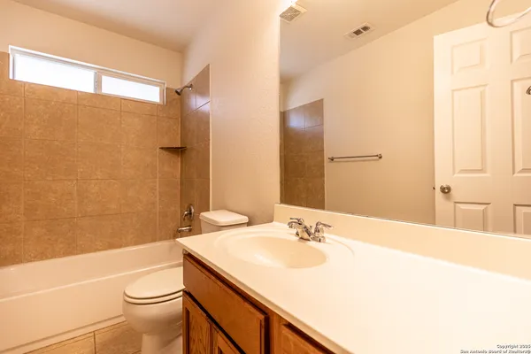 a bathroom with a sink toilet vanity and shower