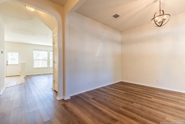 a view of a room with wooden floor and white walls