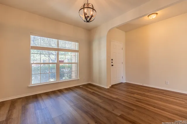 a view of a room with wooden floor and window