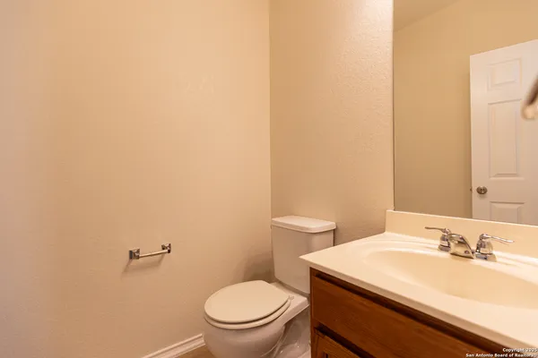 a bathroom with a sink a toilet and a mirror
