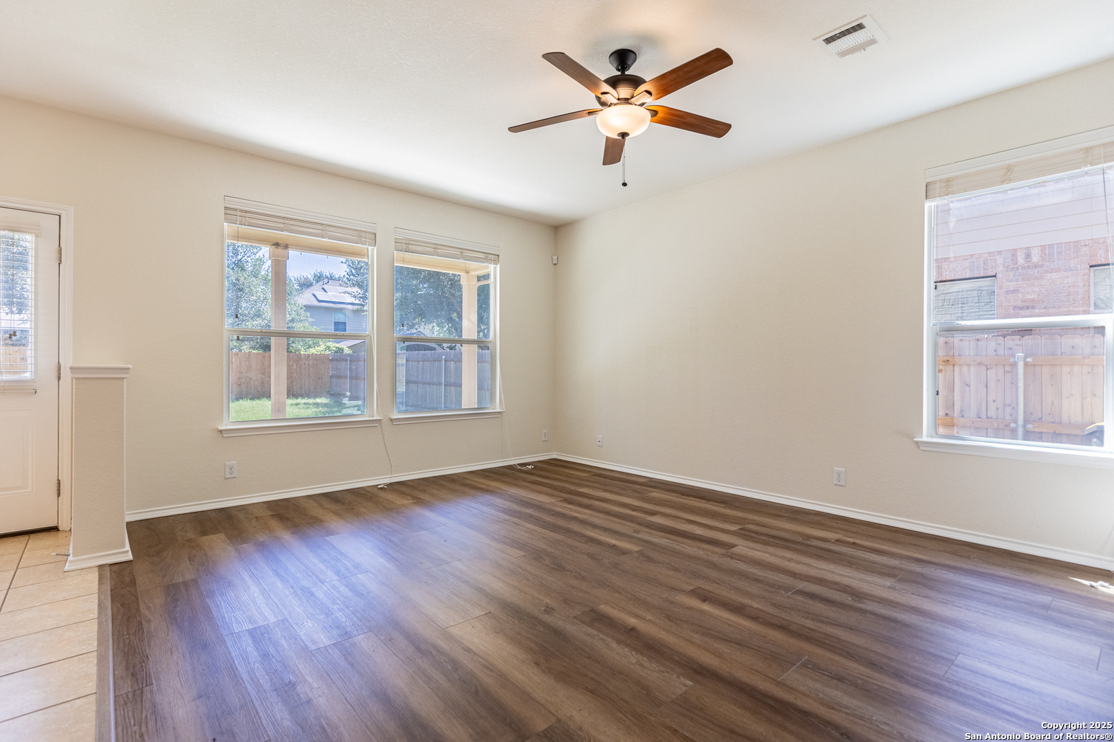 3013 Muntjac Schertz, TX 78154 - Photo 8 of 40 a view of an empty room with a window and wooden floor