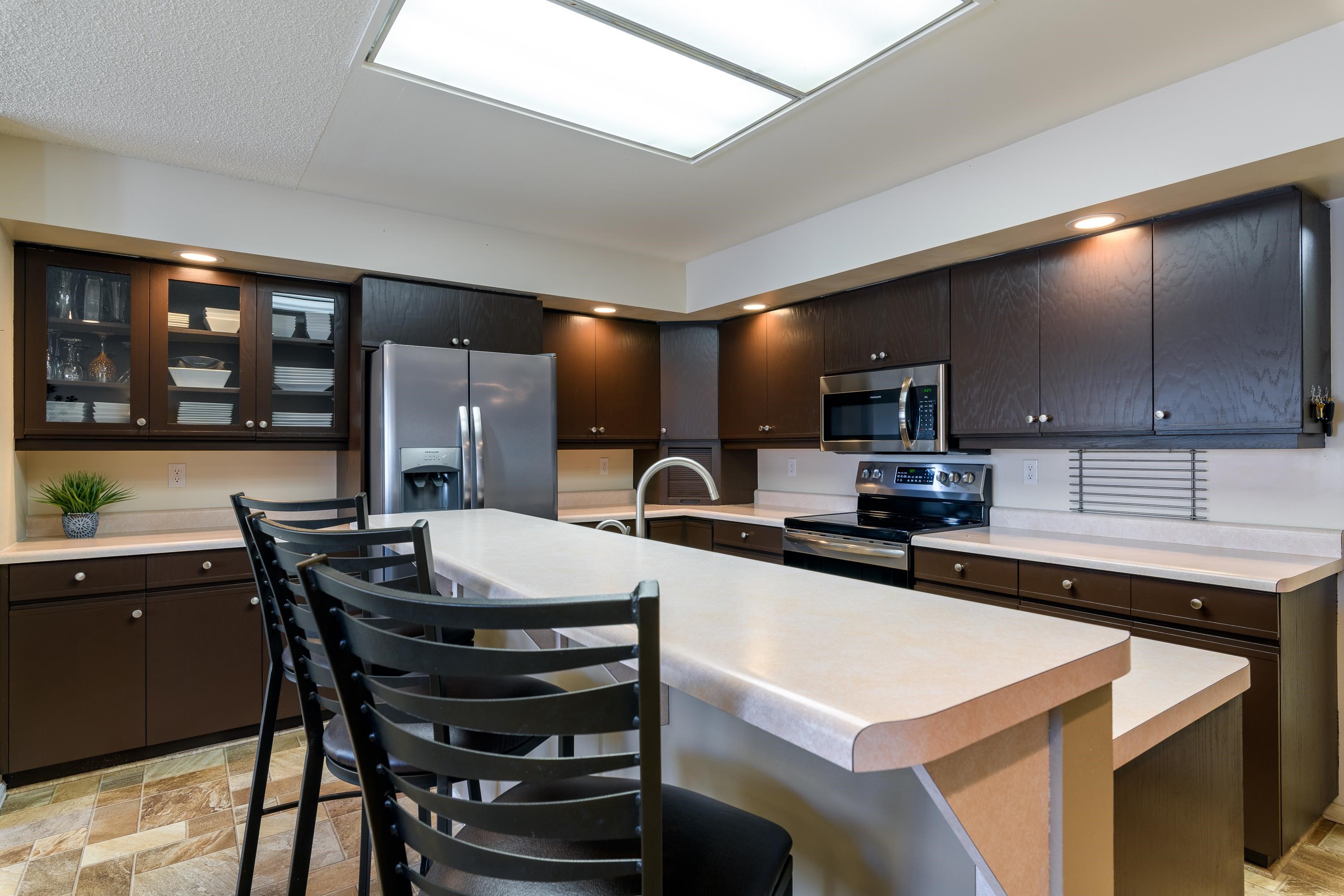 2700 G Road, Unit 5C Grand Junction, CO 81506 - Photo 12 of 25 a kitchen with a table chairs microwave and cabinets