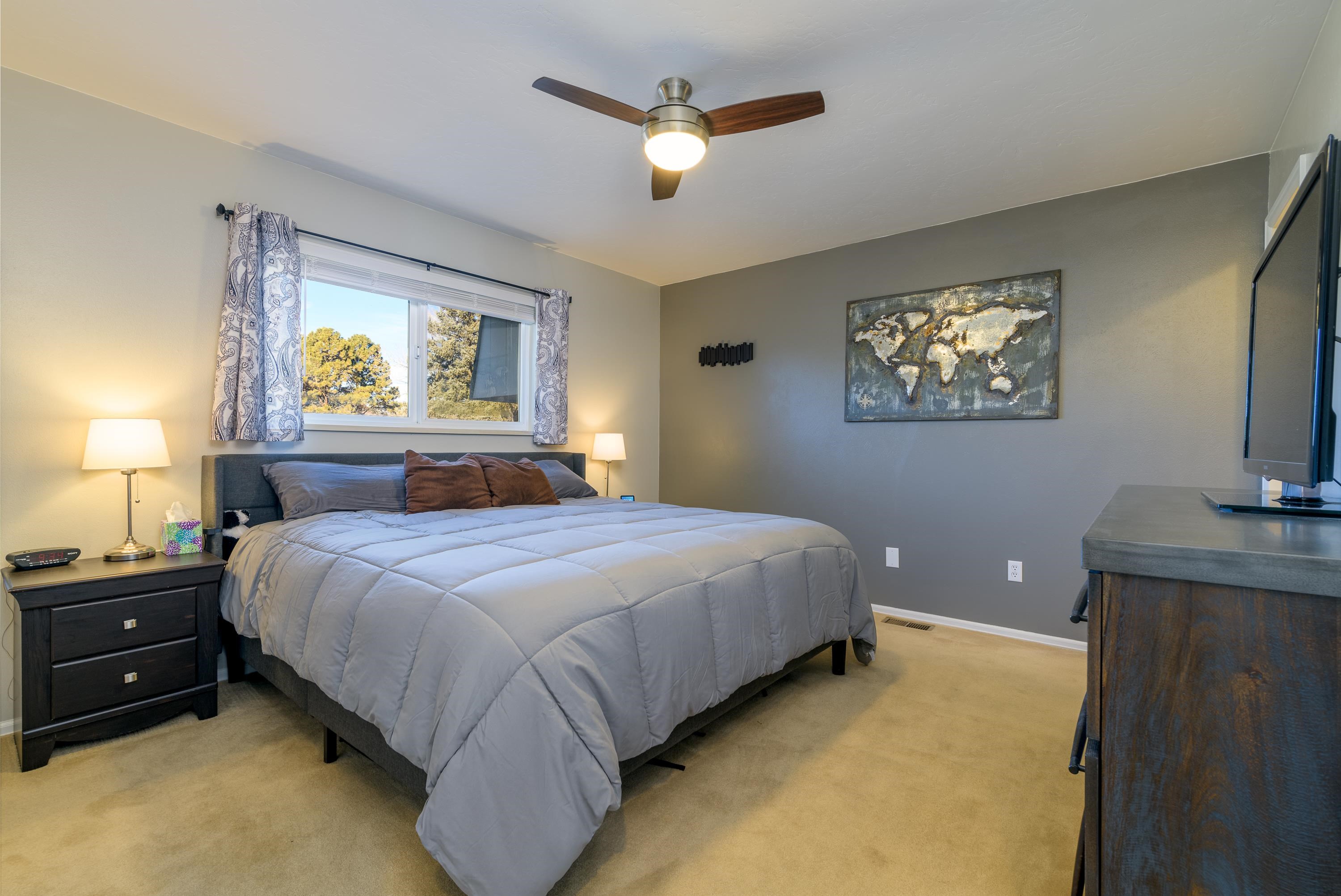 2700 G Road, Unit 5C Grand Junction, CO 81506 - Photo 16 of 25 a bedroom with a bed and a chandelier