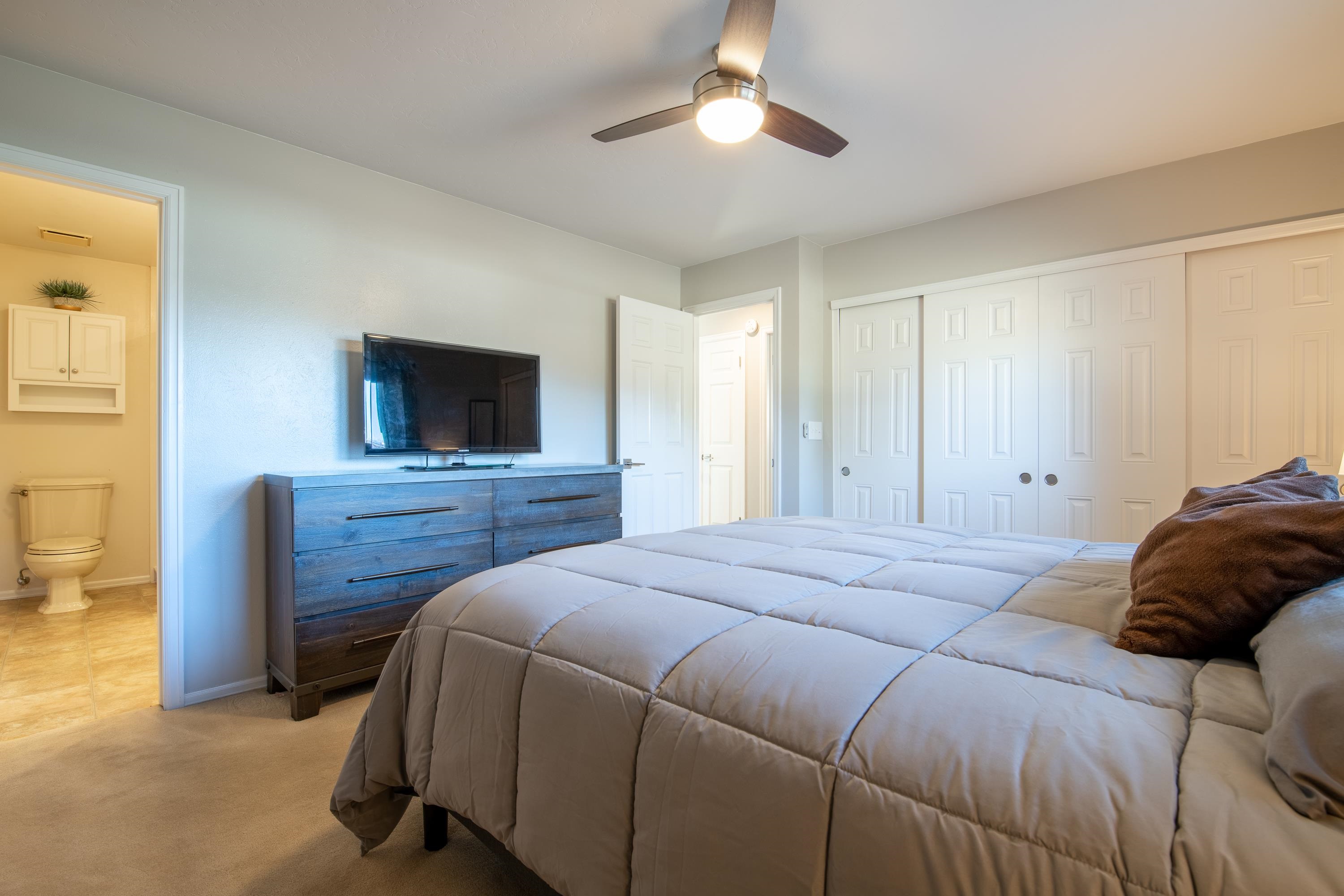 2700 G Road, Unit 5C Grand Junction, CO 81506 - Photo 17 of 25 a bedroom with a bed and a flat screen tv