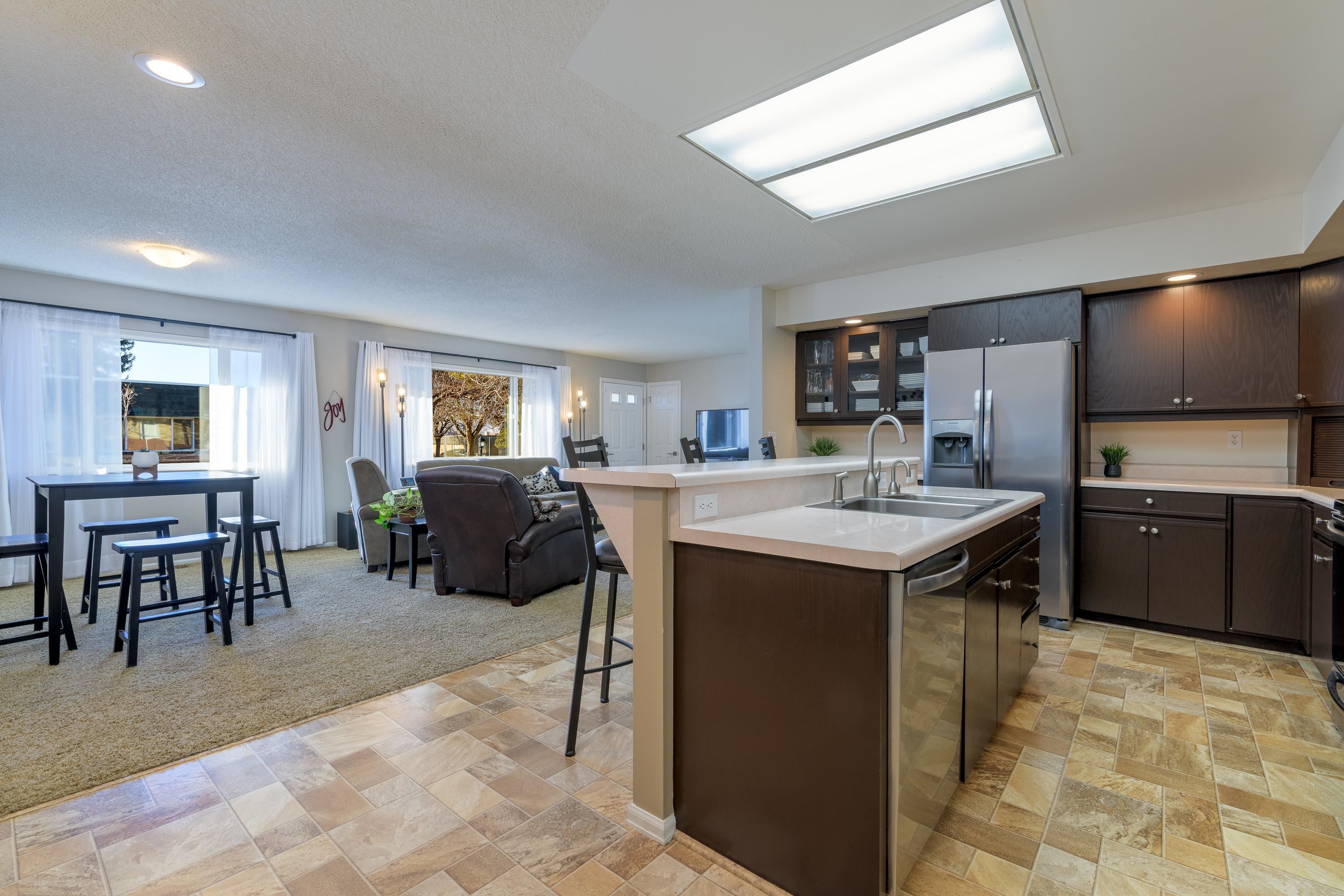 2700 G Road, Unit 5C Grand Junction, CO 81506 - Photo 9 of 25 a kitchen with kitchen island a sink table and chairs