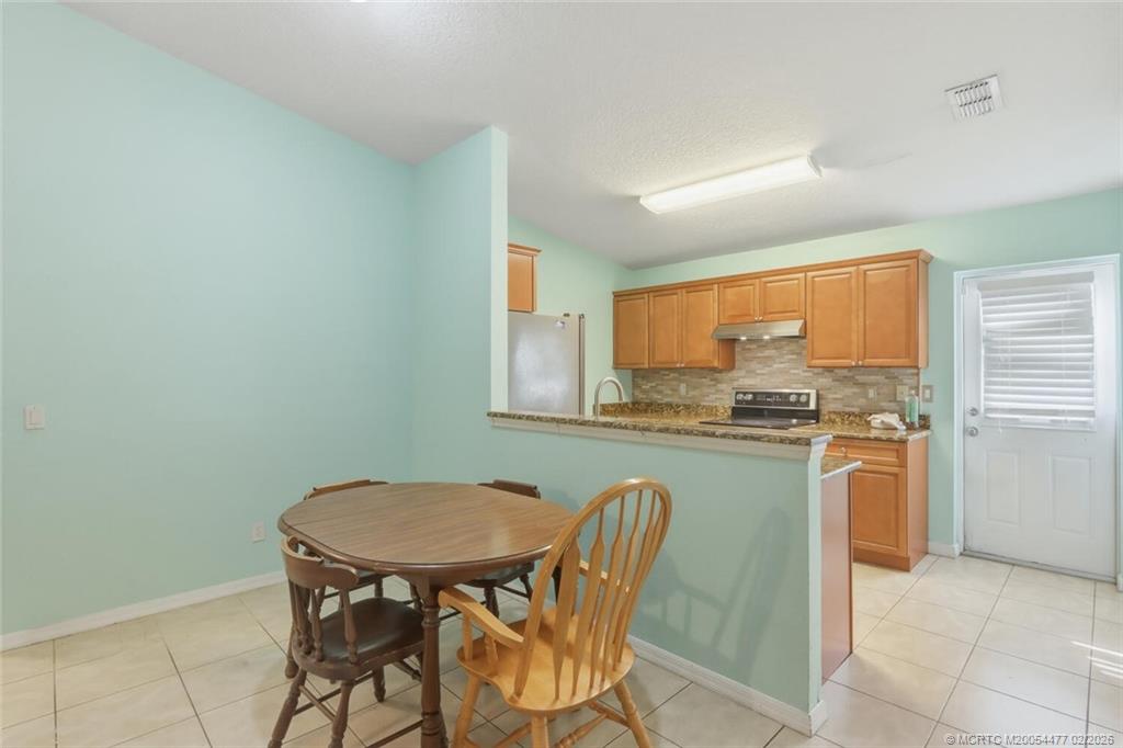 726 Southwest Bond Road Port St. Lucie, FL 34953 - Photo 11 of 31 a view of a dining room with furniture window and outside view