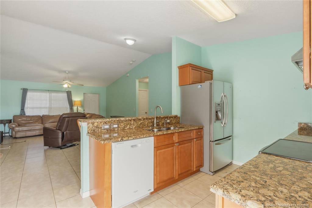 726 Southwest Bond Road Port St. Lucie, FL 34953 - Photo 15 of 31 a kitchen with stainless steel appliances granite countertop a sink and cabinets
