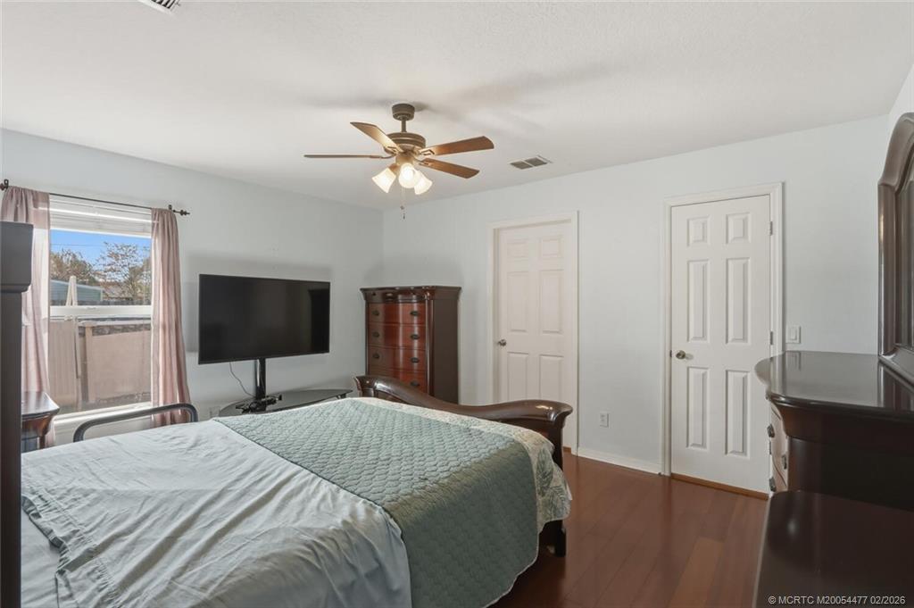 726 Southwest Bond Road Port St. Lucie, FL 34953 - Photo 18 of 31 a bedroom with a bed and a flat screen tv