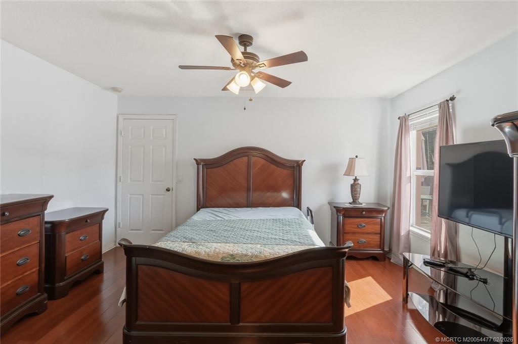 726 Southwest Bond Road Port St. Lucie, FL 34953 - Photo 19 of 31 a bedroom with a bed and a flat screen tv