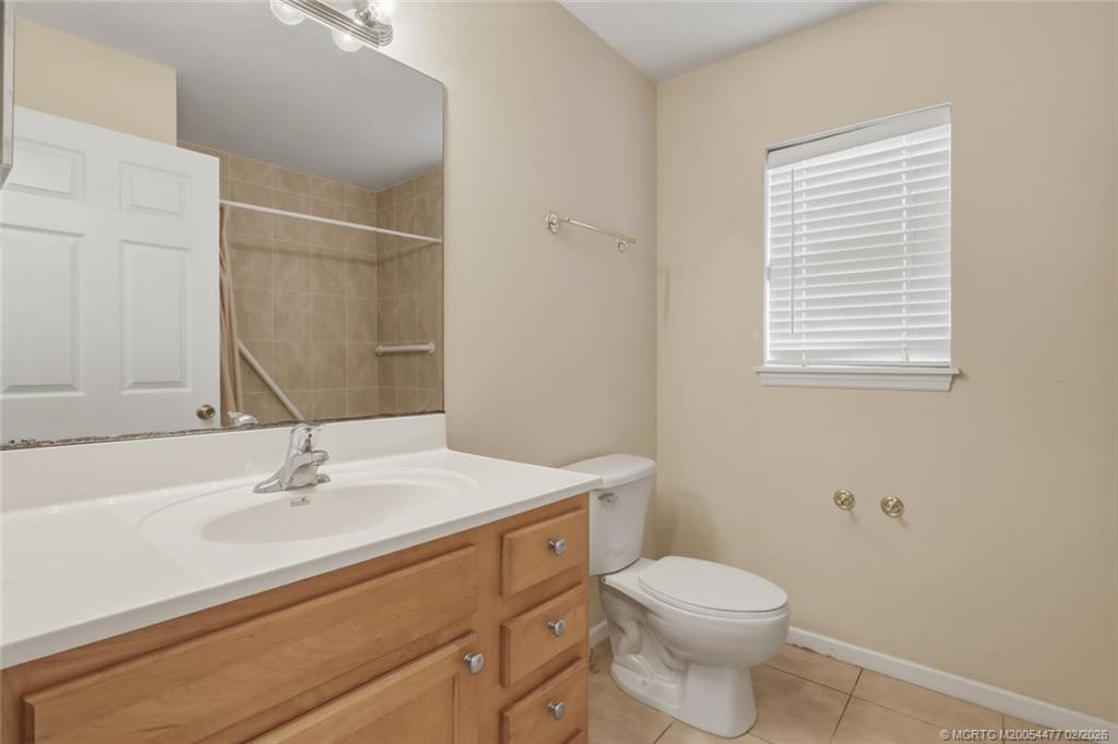 726 Southwest Bond Road Port St. Lucie, FL 34953 - Photo 24 of 31 a bathroom with a sink toilet and mirror