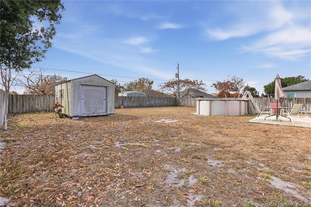726 Southwest Bond Road Port St. Lucie, FL 34953 - Photo 28 of 31 a view of a house with a yard and wooden fence