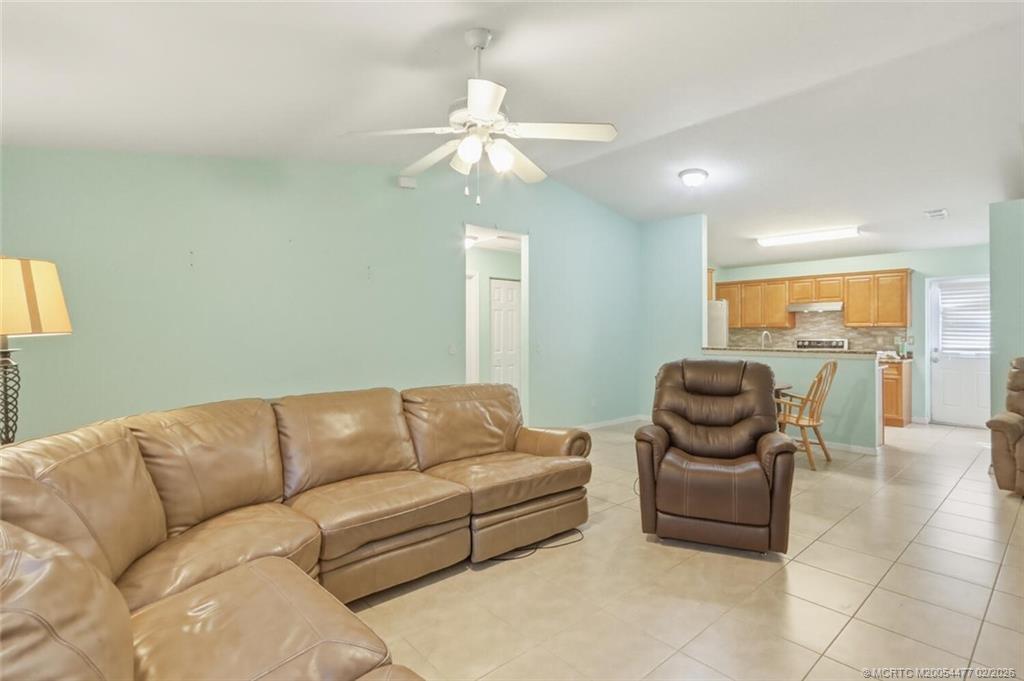 726 Southwest Bond Road Port St. Lucie, FL 34953 - Photo 7 of 31 a living room with furniture and a chandelier