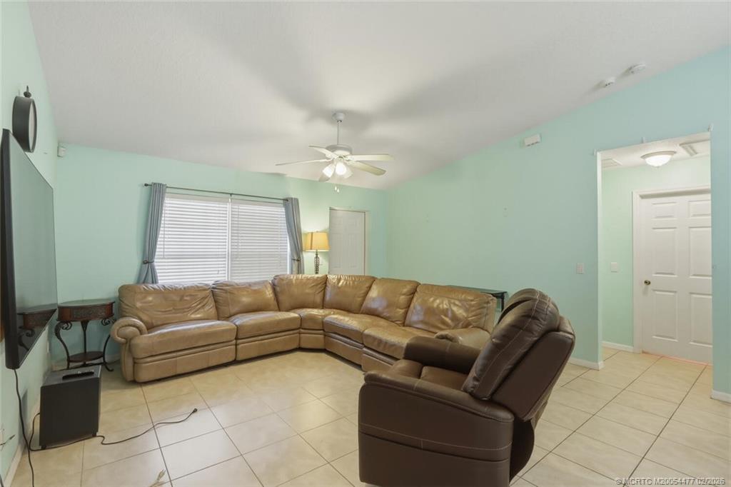 726 Southwest Bond Road Port St. Lucie, FL 34953 - Photo 8 of 31 a living room with furniture and a chandelier
